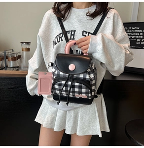 Mini black and white checkered backpack featuring pink straps and a card holder attachment
