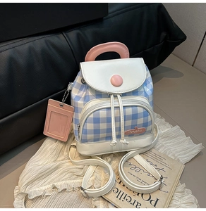 Detail of blue and white checkered canvas mini backpack with pink decorative buckle