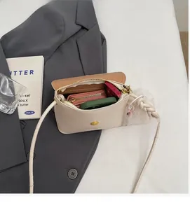 Internal view of cream bucket bag showing spacious main compartment and zipper pocket