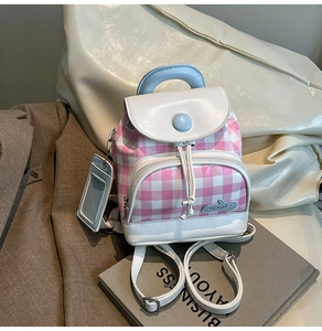 Detail of pink plaid mini backpack with blue handle and matching card holder attachment