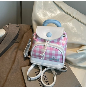 Close-up of mini plaid backpack showing drawstring closure and blue accent details