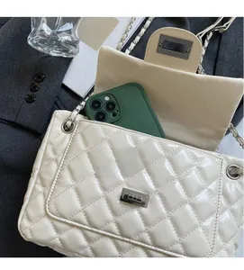 Top view of cream quilted chain bag interior showing large capacity and inner pockets