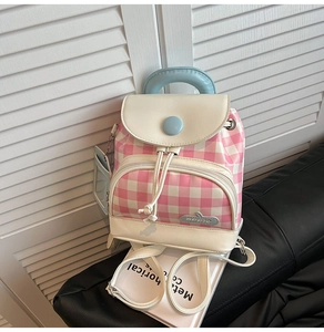 Detail of pink plaid mini backpack with light blue card holder and white faux leather trim
