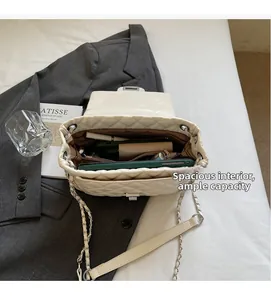 Close-up of the spacious interior of a white quilted chain bag with large capacity