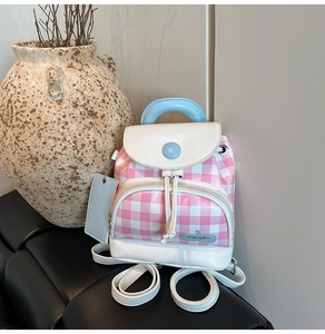 Detail of pink gingham mini backpack with blue handle and front pocket closeup