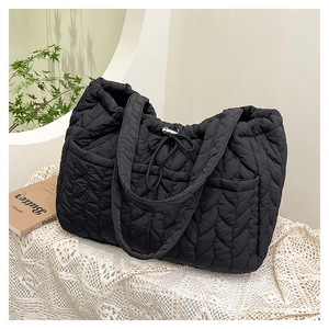 Close-up of heart-shaped quilted pattern on black high-density nylon tote bag