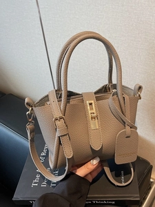 Elephant grey lychee leather bucket bag with top handles and gold hardware lock