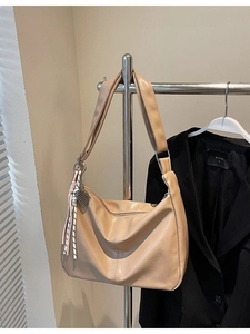 Large beige PU leather dumpling bag with woven charm for women's daily commute
