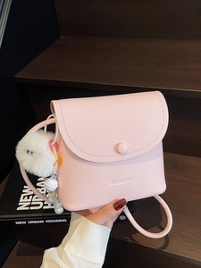 Pink lychee texture PU leather mini crossbody bag with cute white pompom charm accessory