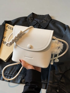 Chic white lychee leather crossbody bag with braided strap and cute plush charm