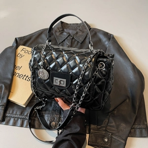 Quilted black chain bag with silver twist lock and circular metallic charm detail