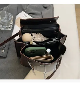 Innenansicht der braunen Handtasche mit Litschiprägung und großem Stauraum für den Alltag