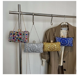 Detailed shot of sparkling rhinestone evening bags in silver, gold, and blue with chain straps