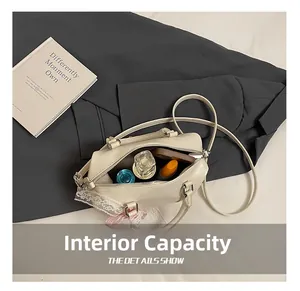 Internal view of beige Boston bag with lace ribbon showing spacious storage for essentials