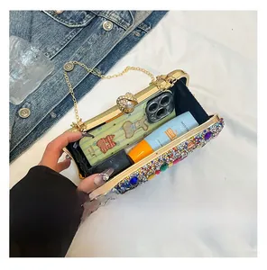 Detail showing the internal capacity of the colorful rhinestone clutch with a gold chain
