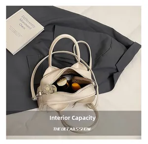 Internal capacity of minimalist cream leather pillow bag showing space for phone and makeup