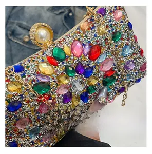 Detail of colorful crystals and rhinestones on a luxury evening clutch with gold chain