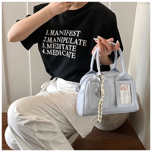 Detail of light blue faux leather handbag with stripe pendant and card slot