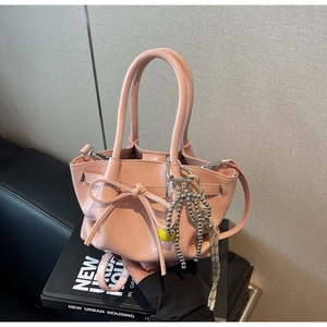 Detailansicht der rosa Kordelzug-Beuteltasche mit Lederschleife und Deko-Anhänger