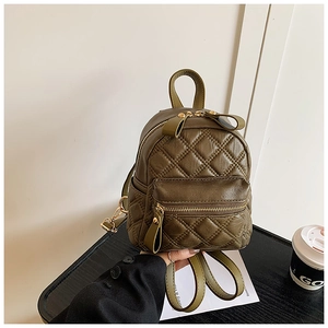 Detail eines armee-grünen gesteppten Mini-Rucksacks mit Deko-Schleife am Reißverschluss