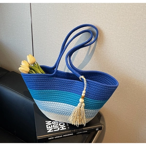 Détail du sac cabas tissé en dégradé bleu avec gland à franges et texture artisanale