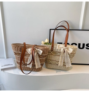 Close-up of woven straw tote bags with delicate lace bows and leather handles