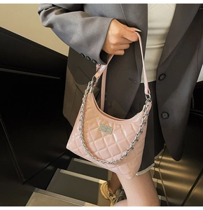 Detail of pink patent leather bag with quilted pattern and silver chain shoulder strap