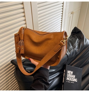 Caramel retro shoulder bag with soft pleated texture and stylish tassel detail