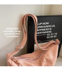 Détail de la bandoulière large réglable avec boucle argentée sur le sac rose