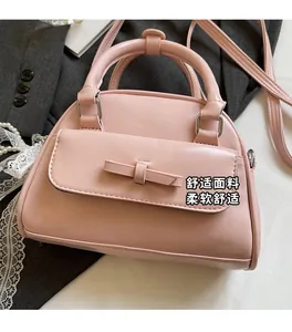 Detailed shot of a pink bowling handbag with a bow knot on a decorative background