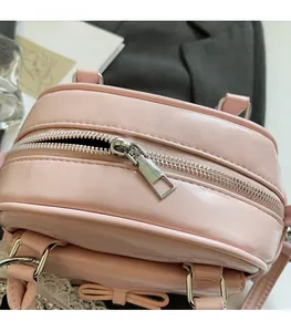 Detail of pink bowling bag featuring silver smooth zipper and pearl bow decoration