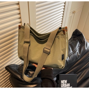 Macro detail of grass green canvas tote with reinforced leather edges and wide strap