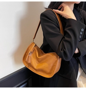 Brown vintage shoulder bag with pleated leather texture and long tassel zipper detail