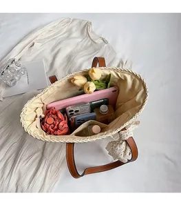 Spacious interior of straw tote bag showing large capacity for tablet and accessories