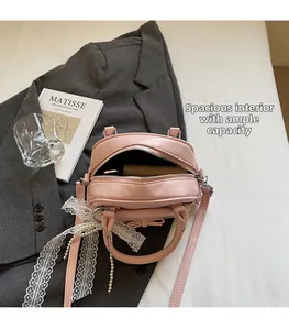 Pink bow handbag with spacious interior compartment showing storage for essentials