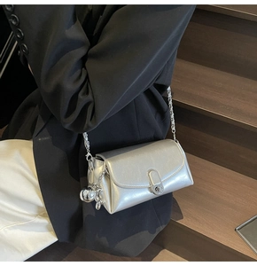 Silver oil wax leather crossbody bag featuring a chic metal buckle and chain strap detail