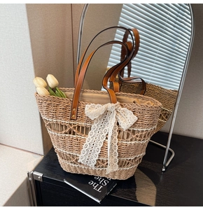 Detail of hand-woven straw tote bag with lace bow decoration and faux tulips inside