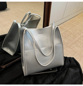 Close-up of silver lychee grain tote bag with white edge paint and embossed logo