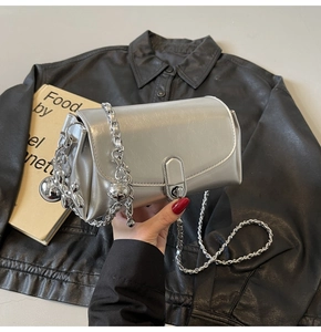 Detail of silver oil wax leather handbag with chunky metal chain and lock