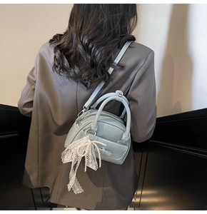 Blue bowling bag detail with white lace bow pearl charm and adjustable shoulder strap