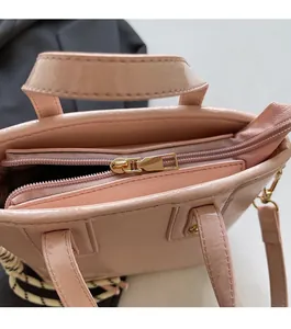 Detail of pink patent leather bucket bag with premium gold zipper and smooth texture