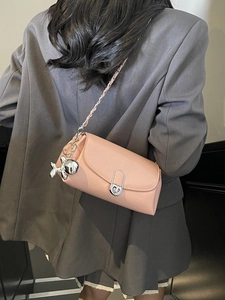 Pink faux leather crossbody bag with silver chain and a cute balloon dog charm