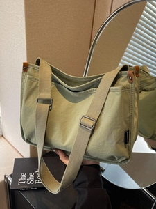 Versatile sage green canvas tote bag with adjustable strap and side pocket for women
