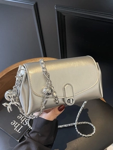 Silver oil wax leather chain bag with a metallic balloon dog charm and rotating buckle