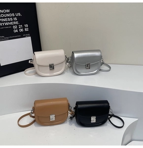Mini leather saddle bags in off-white, silver, tan, and black with geometric metal buckles