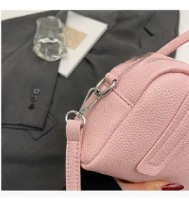 Close-up of pink litchi grain leather bag with premium silver hardware detail
