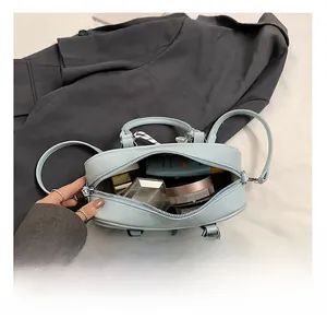 Internal view of light blue Boston bag showing capacity for cosmetics and daily items