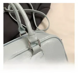 Macro detail of silver hardware and light blue textured leather on the Boston bag