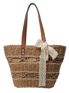 Woven straw beach tote bag with leather handles and lace bow for summer vacation