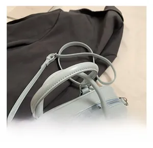 Detailed macro view of light blue leather texture with silver hardware on boston bag